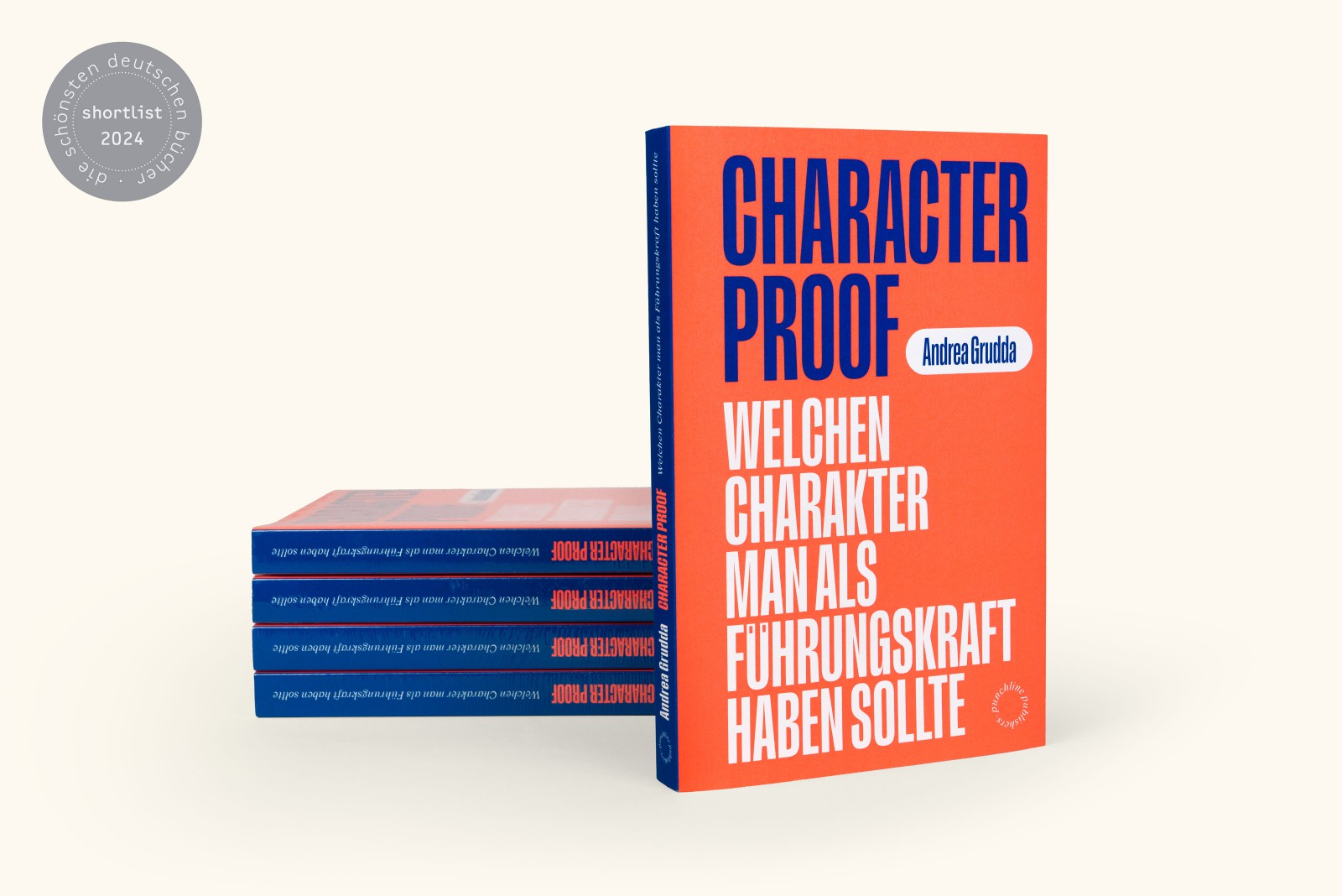 Buchstapel und aufgestelltes Exemplar vom Buch Character Proof mit Shortlist-Badge „Schönste deutsche Bücher 2024"