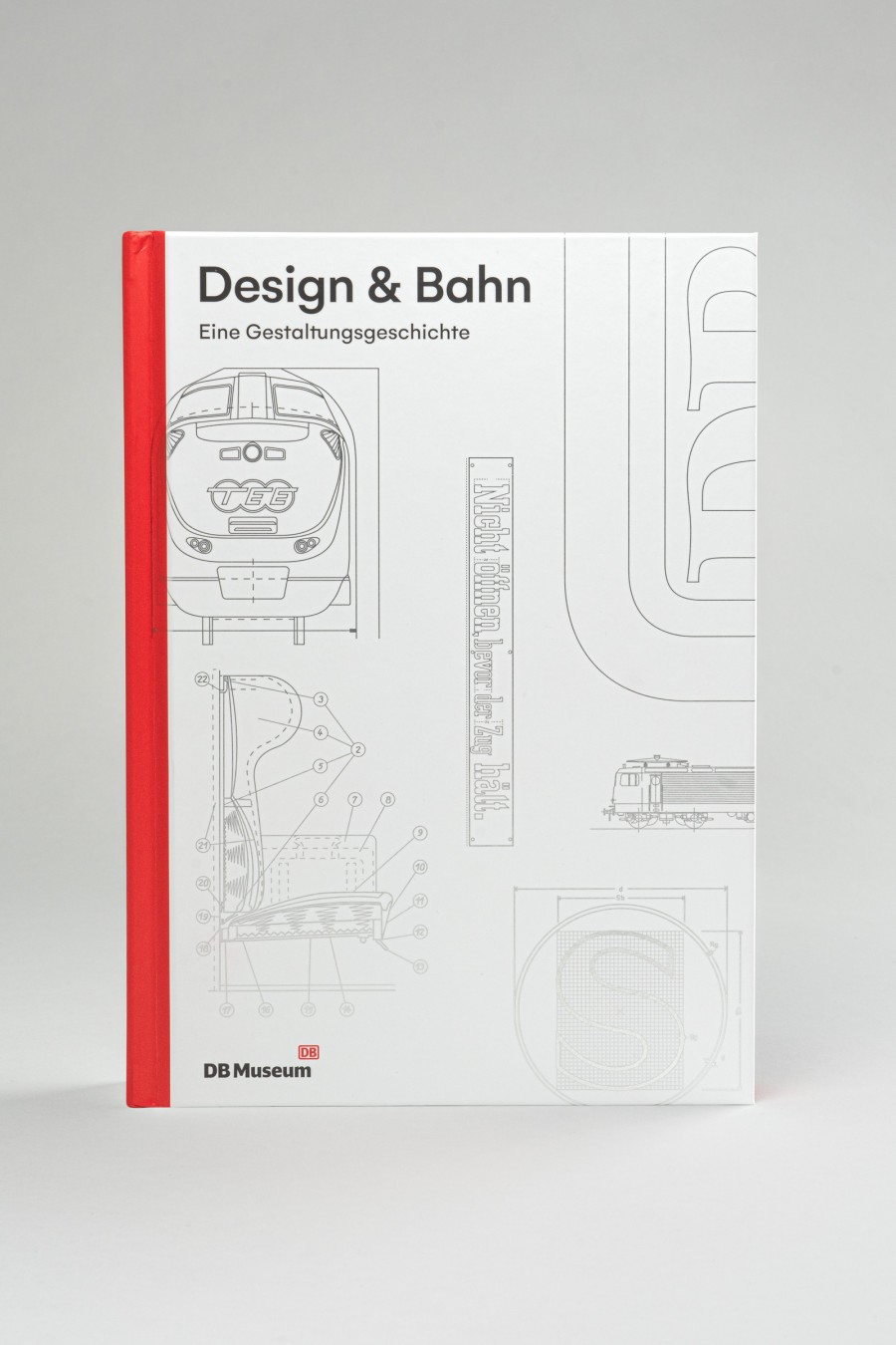 Cover of the book “Design & Bahn” as a museum edition, featuring a red spine, a light-colored background, and technical drawings of a locomotive, the DB logo, and other design elements 