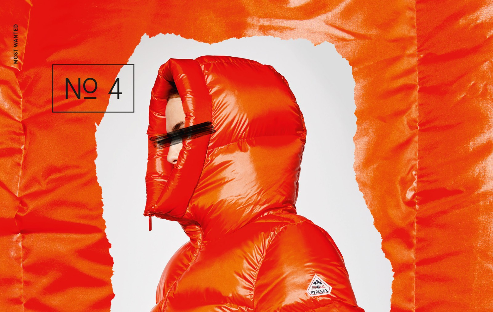 Large-format J'N'C fashion editorial: A person wearing a bright orange, shiny Pyrenex down jacket against a torn orange background, with the words “Most Wanted – No. 4” written on it