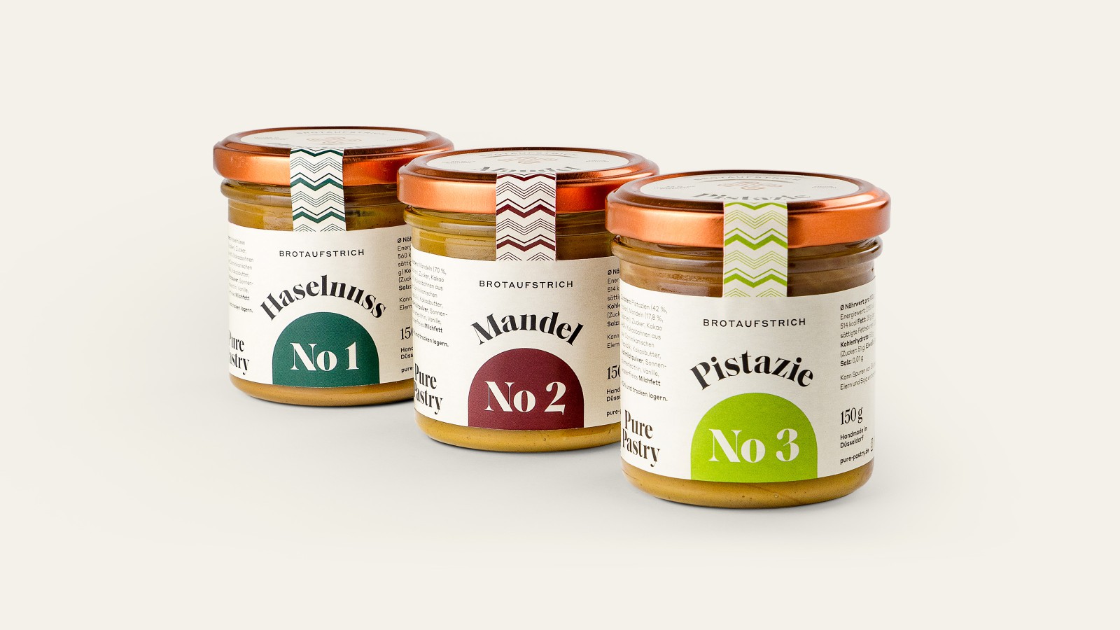 Three Pure Pastry spread jars side by side, each with a copper lid and a custom label: “Hazelnut No. 1,” “Almond No. 2,” and “Pistachio No. 3”