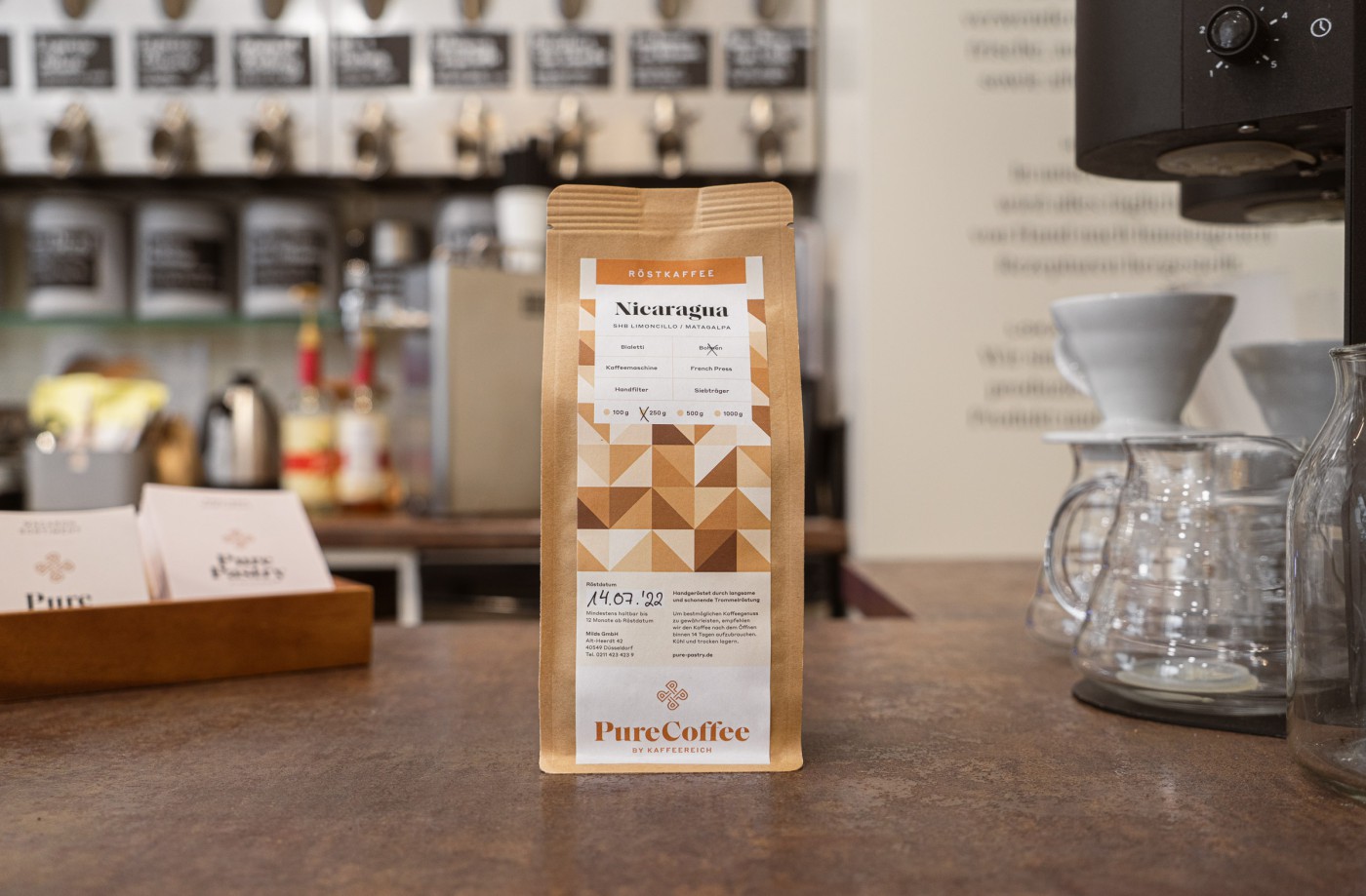 Implementation of the Pure Pastry brand on coffee packaging, chocolate, and in-store praline flyers