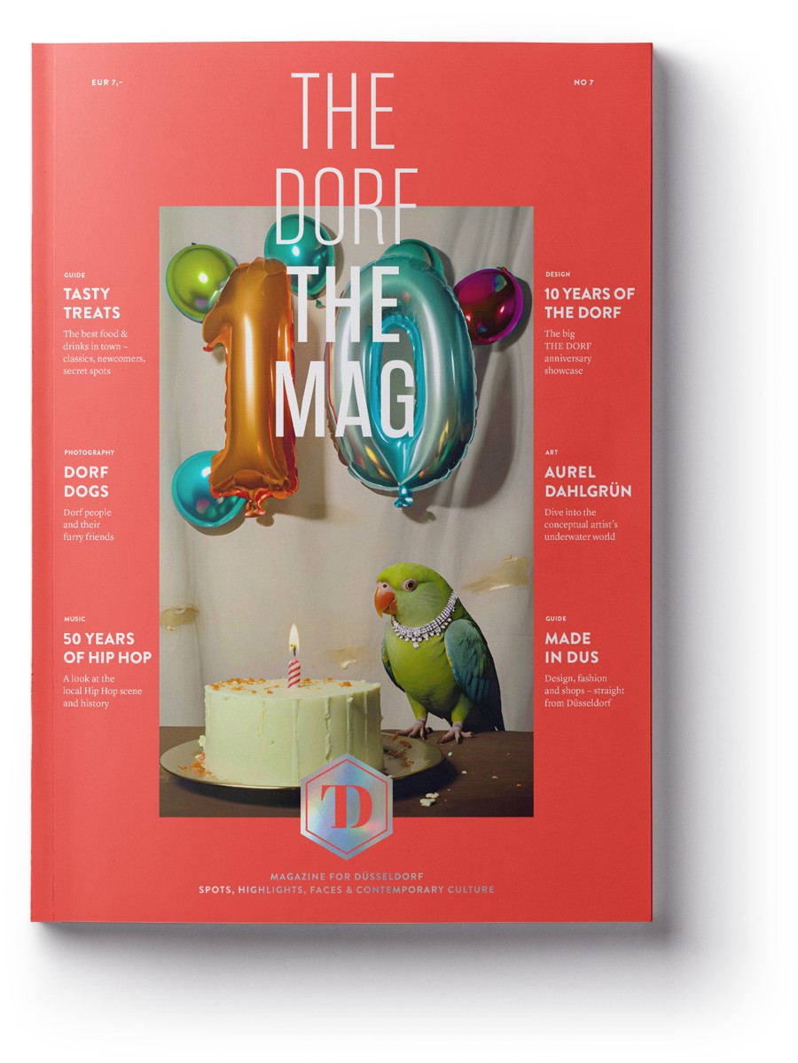 THE DORF THE MAG Issue 7 from 2024, featuring a 10th-anniversary balloon, a cake, and the Kö parrot on a red background